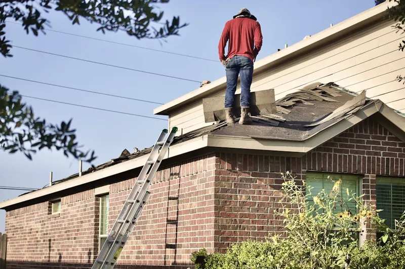 Professional roofer working on a residential roof in Wolfert